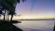 Sunset framed by the ocean, beach and palm trees seen from Chuuk Sunset framed by the ocean, beach and palm trees seen from Chuuk