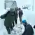 Rescue workers in Uttarakhand state working in deep snow