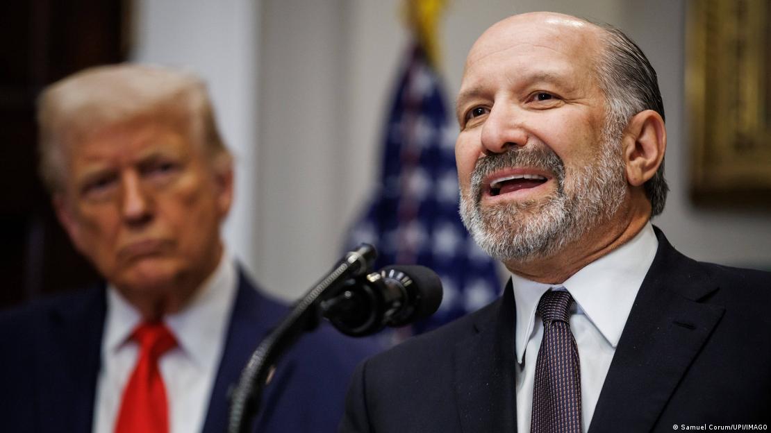 ABD Ticaret Bakanı Howard Lutnick mikrofonda konuşma yapıyor, arkasında Başkan Donald Trump görünüyor