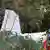 Small aircraft visible among shrubs and tree after crashing into garden on Mar 4, 2025.