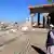 A residents stands next to damaged mosque that was hit during the attack