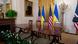 Table with four chairs, US and Ukrainian flags in background Table with four chairs, US and Ukrainian flags in background