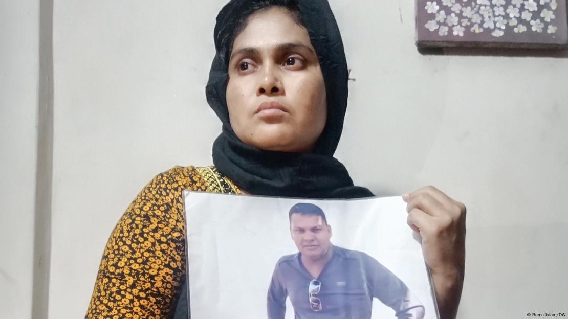 Baby Akhtar with a photo of her husband who remains untraced after men allegedly from the paramilitary battalion RAB picked him up from Dhaka in 2012