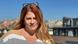 Head shot of a woman (Adrienn Laczo) with long reddish-blond hair standing in the sun Head shot of a woman (Adrienn Laczo) with long reddish-blond hair standing in the sun