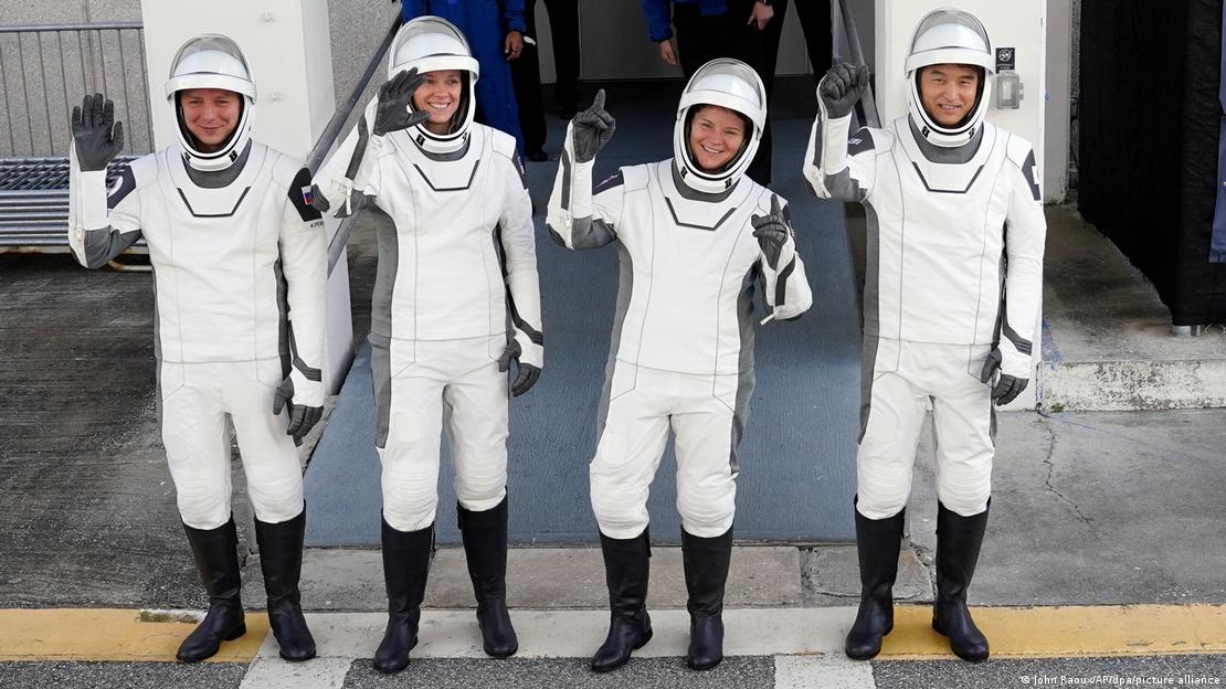 Os astronautas que ficarão na ISS pelos próximos seis meses: o russo Kirill Peskov (Roscosmos); a comandante Anne McClain e Nichole Ayers (Nasa); e o japonês Takuya Onishi (Jaxa). O grupo, vestindo roupas espaciais, sorri e acena para fotógrafos antes de partirem em missão espacial Os astronautas que ficarão na ISS pelos próximos seis meses: o russo Kirill Peskov (Roscosmos); a comandante Anne McClain e Nichole Ayers (Nasa); e o japonês Takuya Onishi (Jaxa). O grupo, vestindo roupas espaciais, sorri e acena para fotógrafos antes de partirem em missão espacial
