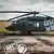 Ein Black Hawk Militärhubschrauber steht auf einem Rollfeld. Auf dem Rumpf des Hubschraubers steht mit weißer Schrift "Čest Mír". Im linken Vordergrund des Bildes ist ein aufgedrucktes Emblem zu sehen, das ein eingepacktes Geschenk zeigt und die englische Aufschrift "Gift for Putin". Auf der rechten Seite ist die Internetadresse "weaponstoukraine.com" aufgedruckt