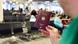 A man holds up a German passport in the middle of a busy airport waiting area A man holds up a German passport in the middle of a busy airport waiting area