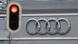 A traffic light set to red can be seen in front of the Audi rings at Audi headquarters A traffic light set to red can be seen in front of the Audi rings at Audi headquarters
