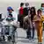 Personas migrantes, entre ellos niños y un hombre en silla de ruedas, llegan al Aeropuerto Internacional Simón Bolívar, en Venezuela, tras haber sido deportadas de Estados Unidos por el Gobierno de Donald Trump.