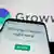 A cellphone displaying the website of Indian fintech company Groww with the Groww logo in the background 