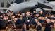 French President Emmanuel Macron stands amid French airforce personnel with a Dassault Rafale fighter jet behind him on March 18, 2025. French President Emmanuel Macron stands amid French airforce personnel with a Dassault Rafale fighter jet behind him on March 18, 2025.
