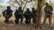 Cameroonian soldiers kneeling alongside a US solder during a military exercise Cameroonian soldiers kneeling alongside a US solder during a military exercise