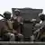 File Photo: Ghanaian soldiers in a truck bearing arms and in full military gear.