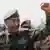 Sudan's de facto leader Abdel Fattah al-Burhan raises his fist outside the presidential palace in Khartoum