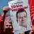A person holds a placard during a rally to protest against the arrest of Istanbul Mayor Ekrem Imamoglu