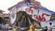 People inspect a collapsed building