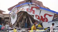 People inspect a collapsed building