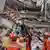 Members of a Chinese search and rescue team transfer a pregnant survivor from a collapsed building in the aftermath of an earthquake in Mandalay