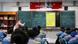 Students in school uniforms at a Tibetan middle school in the city of Nyingchi learn the Tibetan language. Hanging in the classroom are the Chinese national flag, the flag of the Communist Party, a portrait of President Xi Jinping, and photos of past CCP leadership generations