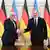 Frank-Walter Steinmeier und Ilham Alijew reichen sich die Hand vor Flaggen ihrer Länder in Baku am 2. April 2025