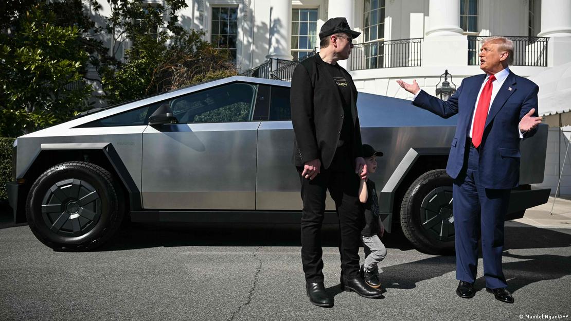 Elon Musk and Donald Trump talk in front of Tesla car at White House