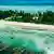 A long section of beach in Tuvalu with the Pacific Ocean on both sides.