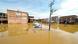 Buildings and cars submerged by flood water Buildings and cars submerged by flood water