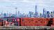 Shipping containers are seen at the Port Jersey Container Terminal, with the Manhattan skyline in the distance Shipping containers are seen at the Port Jersey Container Terminal, with the Manhattan skyline in the distance
