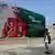 A man walks past a billboard showing Brice Clotaire Oligui Nguema, presidential candidate and Gabonese junta leader.