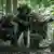 German Bundeswehr soldiers in camouflage gear during military exercise in woods