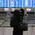 A woman is seen looking at empty check-in counters at Eleftherios Venizelos International Airport