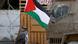 A man with a Palestinian flag in the West Bank A man with a Palestinian flag in the West Bank