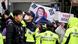 Police stand in front of pro-Yoon supporters on the side of a road as they wait for the arrival of former South Korean president Yoon Suk Yeol (pictured on flag) outside the Central District Court in Seoul on April 14, 2025 Police stand in front of pro-Yoon supporters on the side of a road as they wait for the arrival of former South Korean president Yoon Suk Yeol (pictured on flag) outside the Central District Court in Seoul on April 14, 2025