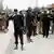 Pakistani security officials inspect the scene of an explosion of an improvised explosive device in Peshawar, Pakistan (August 2024)