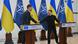 Mark Rutte and Volodymyr Zelenskyy shake hands in front of flags Mark Rutte and Volodymyr Zelenskyy shake hands in front of flags