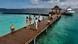 Tourists walking along a wharf in the Maldives Tourists walking along a wharf in the Maldives