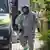 A man at the scene of the ricin raid in Saxony wearing a hazmat suit