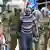 Tanzania police officers detain a supporter of the opposition Chadema party leader Tundu Lissu