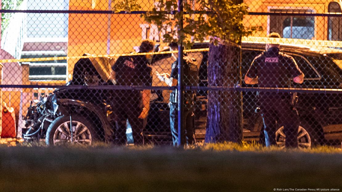 Police examine a black car suspected to be involved at a scene after a vehicle drove into a crowd at the Lapu Lapu Festival in Vancouver, Canada, on April 26, 2025