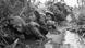 Vietnamese people, including children, look scared crouching in a muddy canal as they take cover, west of Saigon in 1966 Vietnamese people, including children, look scared crouching in a muddy canal as they take cover, west of Saigon in 1966
