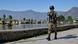 An Indian paramilitary personnel patrols the banks of a lake in Kashmir An Indian paramilitary personnel patrols the banks of a lake in Kashmir