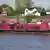The pink houseboat in which a 58-year-old woman was found dead is moored at a jetty on the Holzhafen embankment in Hamburg's Moorfleet district, Germany