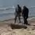Ukrainian servicemen stand near a 500 kg Russian high explosive aerial bomb detected in the area of Black Sea transport corridor, implemented by Ukraine after Russia terminated the UN-brokered Black Sea Grain Initiative, amid Russia's attack on Ukraine, in Odesa, Ukraine April 29, 2025.