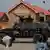 An armored vehicle of Nigerian Security Forces drives by newly built homes, ahead of the community re-opening ceremony which was destroyed by Boko Haram armed militants in 2015, in Ngarannam, Borno State, Nigeria