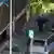 Police experts search for evidences after a bomb explosion outside an National Bank branch in Thessaloniki