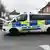 A UK police van drives on the road