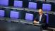 Friedrich Merz sitting alone in the Bundestag