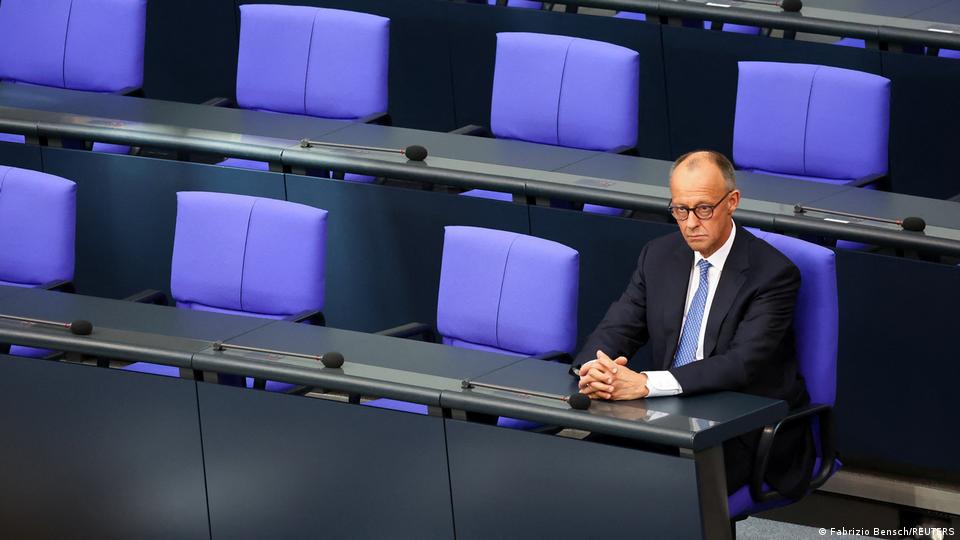 Friedrich Merz sitting alone in the Bundestag