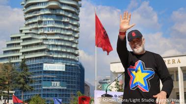 Prime Minister Edi Rama, dressed in a black cap and a black sweater with a yellow star on a blue-black-and-red background, waves to supporters during the opening rally of his party's campaign for the May 11 general election, Tirana, Albania, April 12. An Albanian flag flies in the background Prime Minister Edi Rama, dressed in a black cap and a black sweater with a yellow star on a blue-black-and-red background, waves to supporters during the opening rally of his party's campaign for the May 11 general election, Tirana, Albania, April 12. An Albanian flag flies in the background