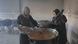 Women in Gaza soup kitchen prepare vat of soup